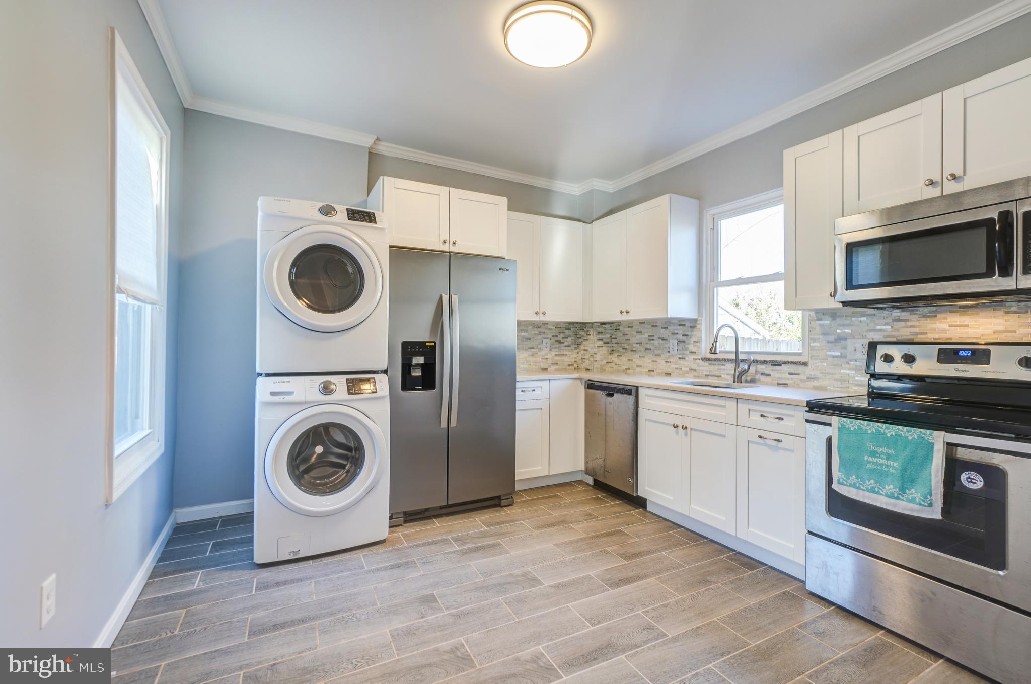35 4th Street Laurel, MD 20707 - Photo 11 of 31 a kitchen with a stove top oven sink and cabinets