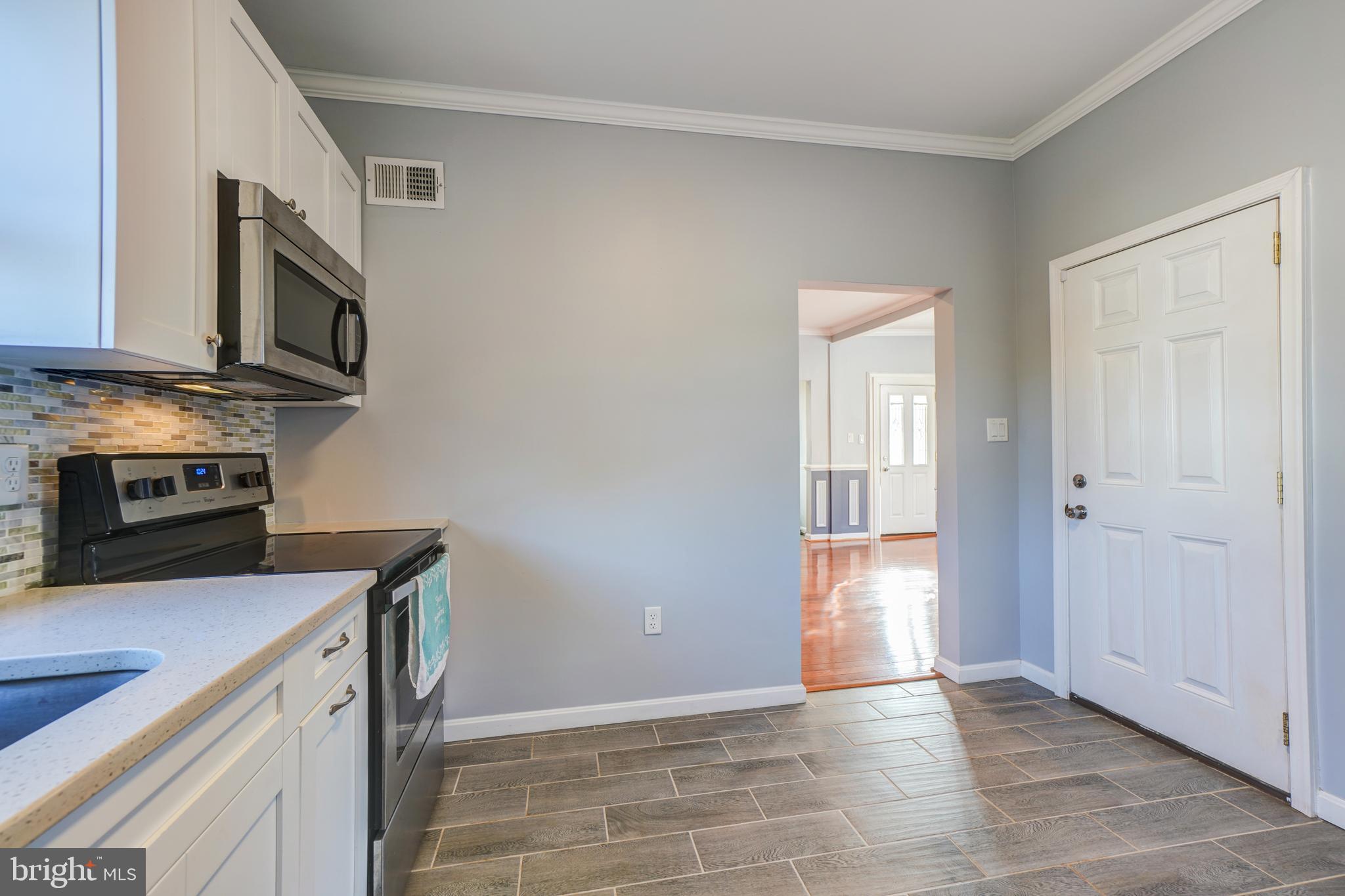 35 4th Street Laurel, MD 20707 - Photo 15 of 31 a kitchen with stainless steel appliances granite countertop a refrigerator and a stove