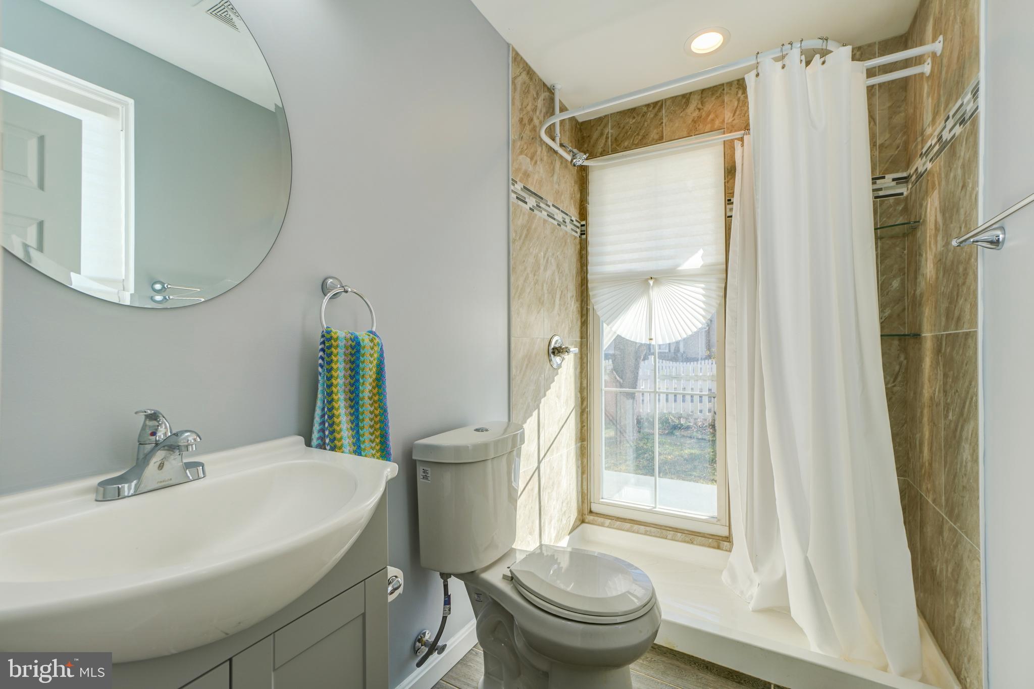 35 4th Street Laurel, MD 20707 - Photo 20 of 31 a bathroom with a sink toilet and shower