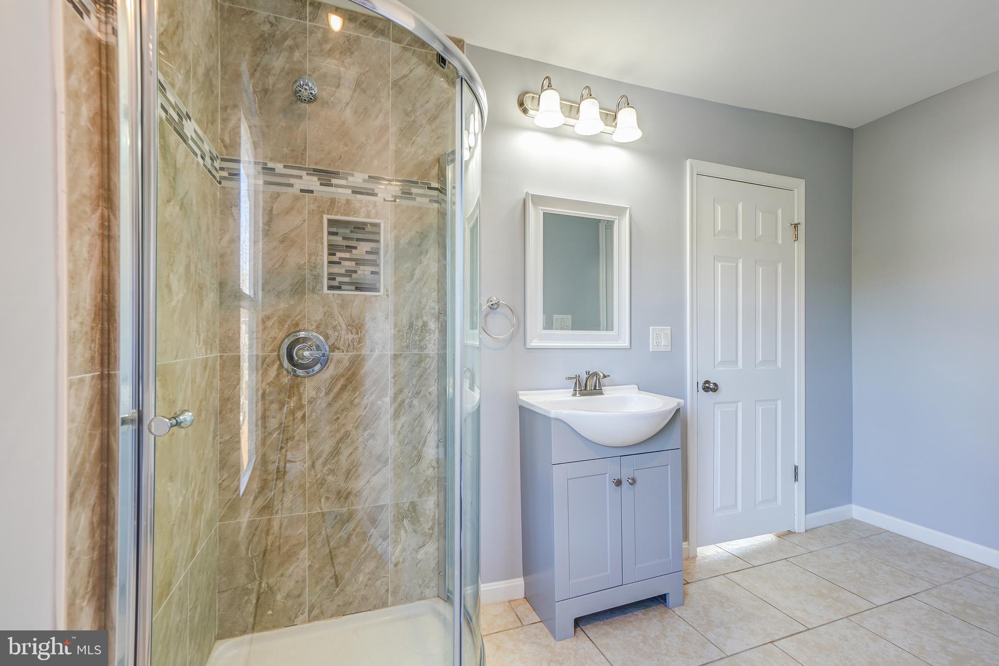 35 4th Street Laurel, MD 20707 - Photo 24 of 31 a bathroom with a granite countertop sink toilet and shower