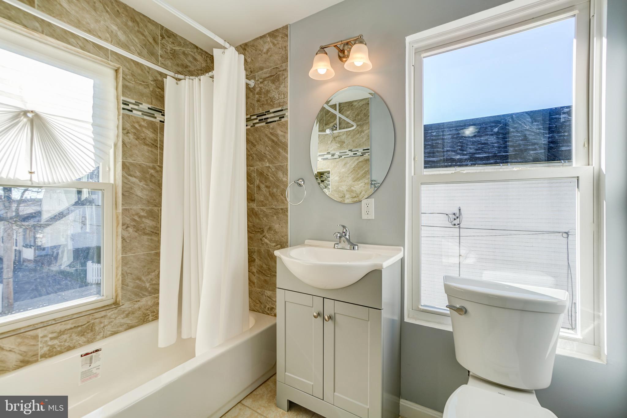 35 4th Street Laurel, MD 20707 - Photo 30 of 31 a bathroom with a toilet sink and mirror