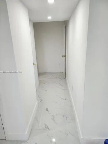 a white toilet sitting next to a shower