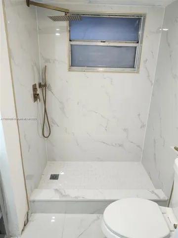 a white toilet sitting next to a bathroom sink