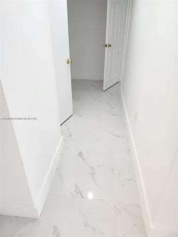 a kitchen with a sink and a large mirror