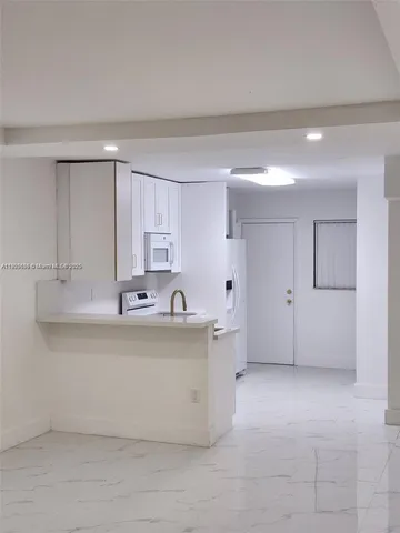 a kitchen with a stove and a microwave