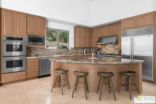 a bedroom with a large bed and a flat screen tv