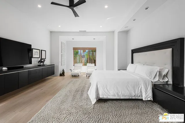 a view of a patio with couches table and chairs and potted plants
