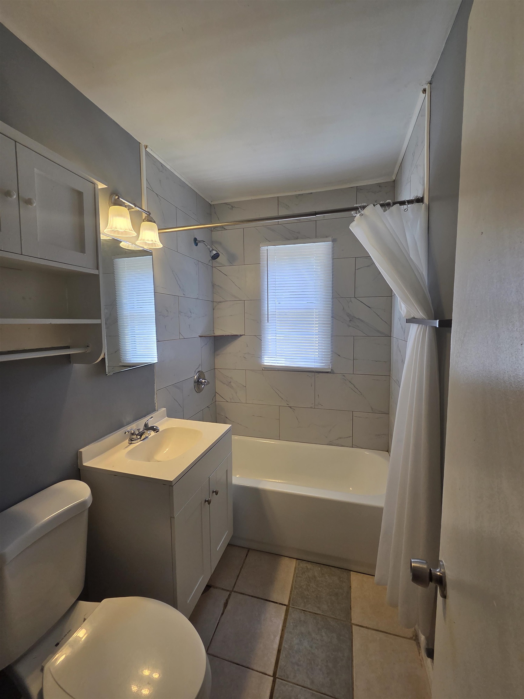3166 Winslow Road Memphis, TN 38109 - Photo 14 of 17 Full bath featuring vanity, shower / bath combo, and light tile patterned flooring