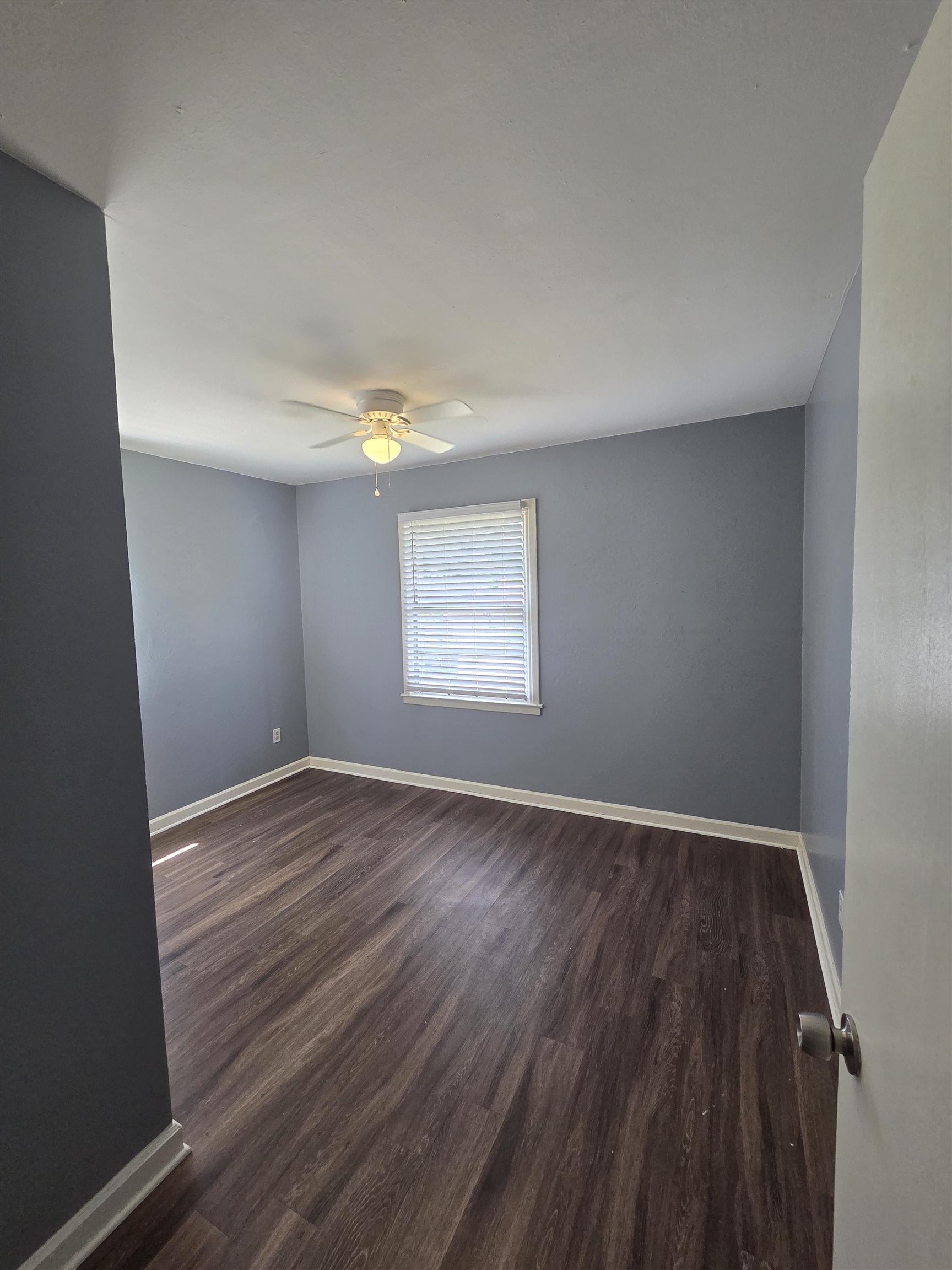 3166 Winslow Road Memphis, TN 38109 - Photo 7 of 17 Empty room featuring dark wood-style flooring and a ceiling fan