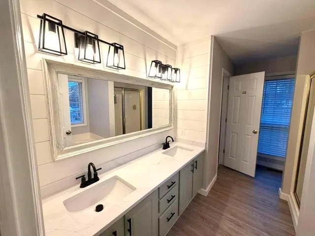 a bathroom with a sink and a large mirror