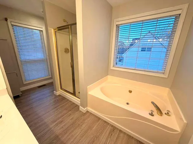 a bathroom with a tub and a window