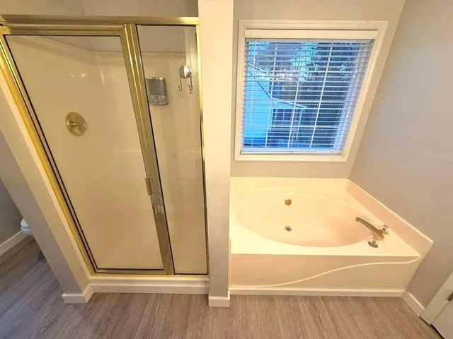 a bathroom with a tub and a shower