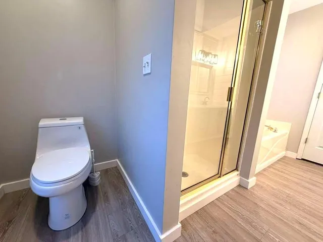 a bathroom with a toilet and a glass door