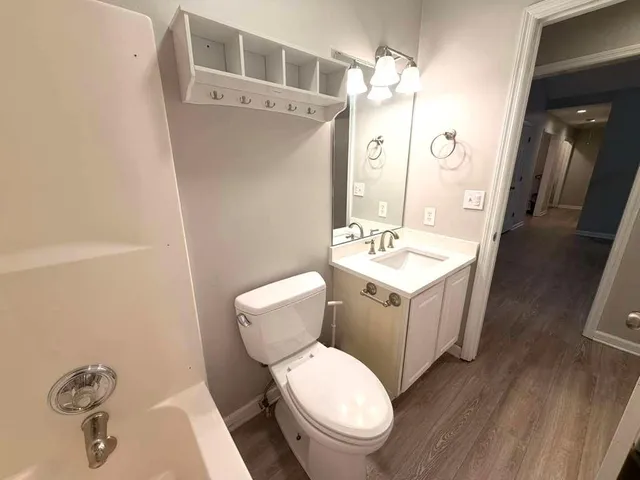 a bathroom with a toilet a sink and mirror