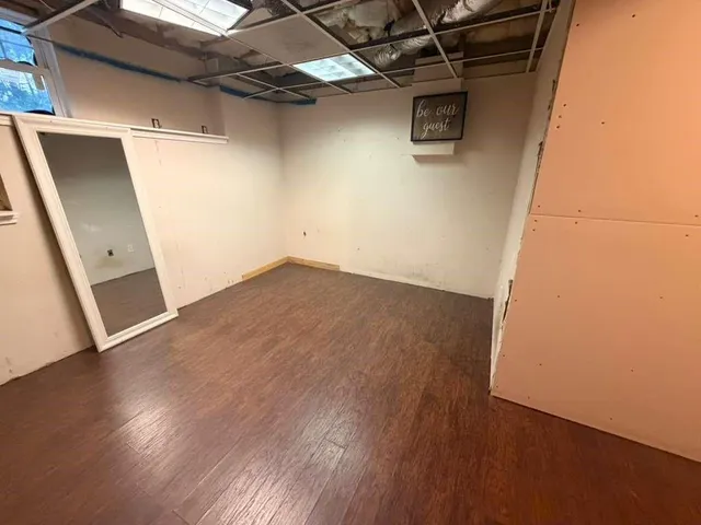 a view of a room with wooden floor