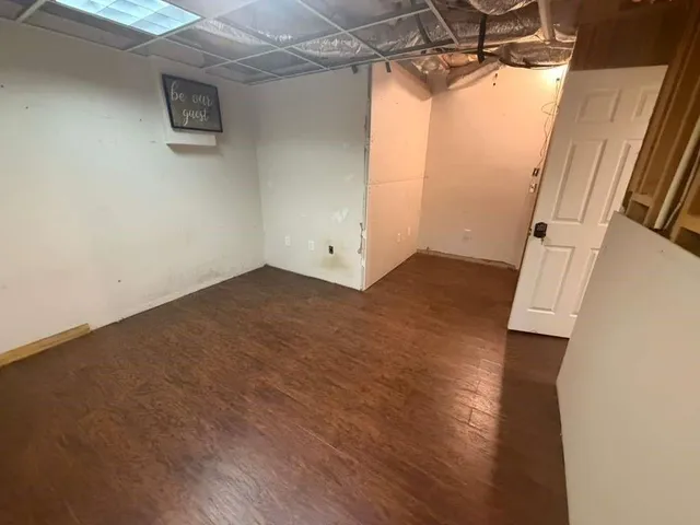 a view of a room with wooden floor and cabinet