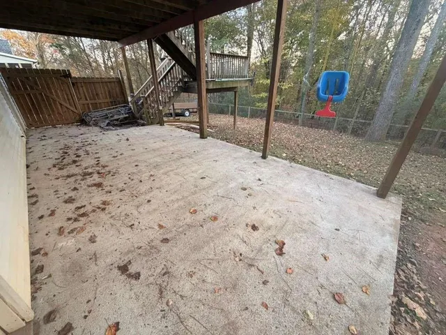 a backyard of a house with a sink and wooden fence