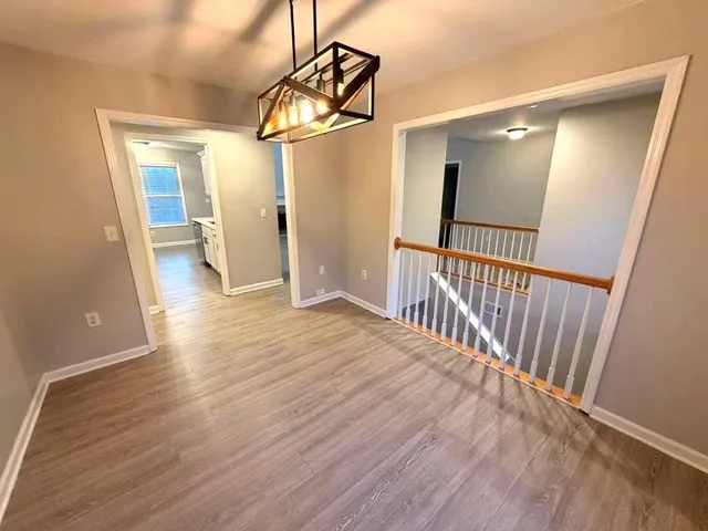 a view of a hallway view with wooden floor and staircase