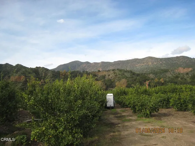 a view of a house with a mountain in the background