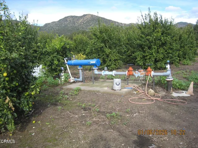 a view of a chairs and table in the backyard