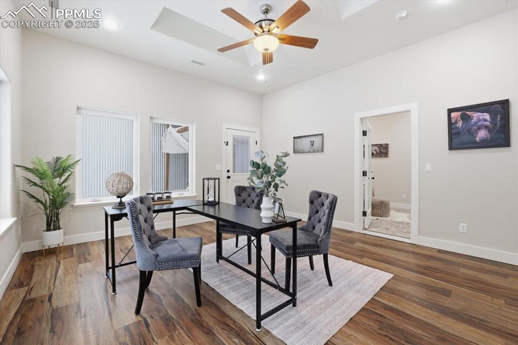 15755 Fool's Gold Lane Colorado Springs, CO 80921 - Photo 23 of 50 a view of a dining room with furniture and wooden floor
