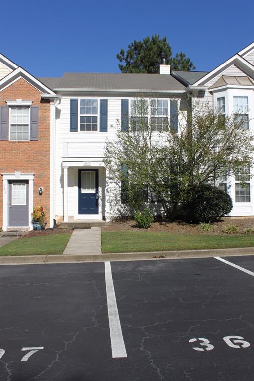 a front view of a house with a yard and a garage