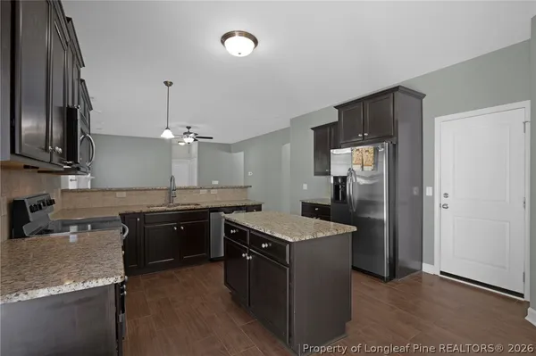 a sink with granite countertop a sink and cabinets