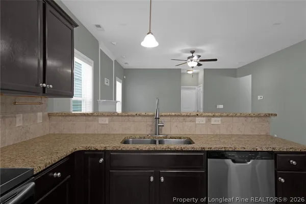 a kitchen with granite countertop a stove and a microwave