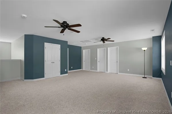 a view of a livingroom with a window and a ceiling fan