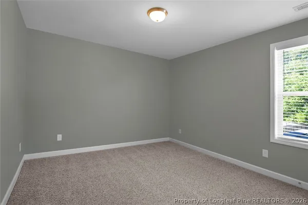 an empty room with closet area