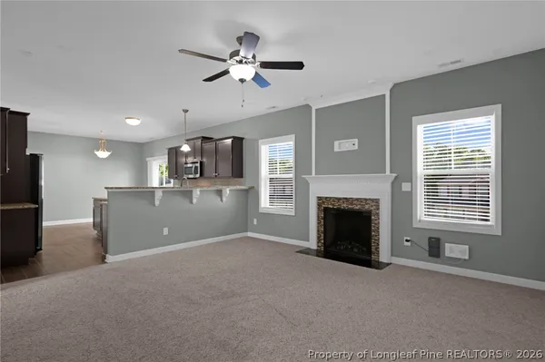 a view of a livingroom with a kitchen space a sink dishwasher and a refrigerator
