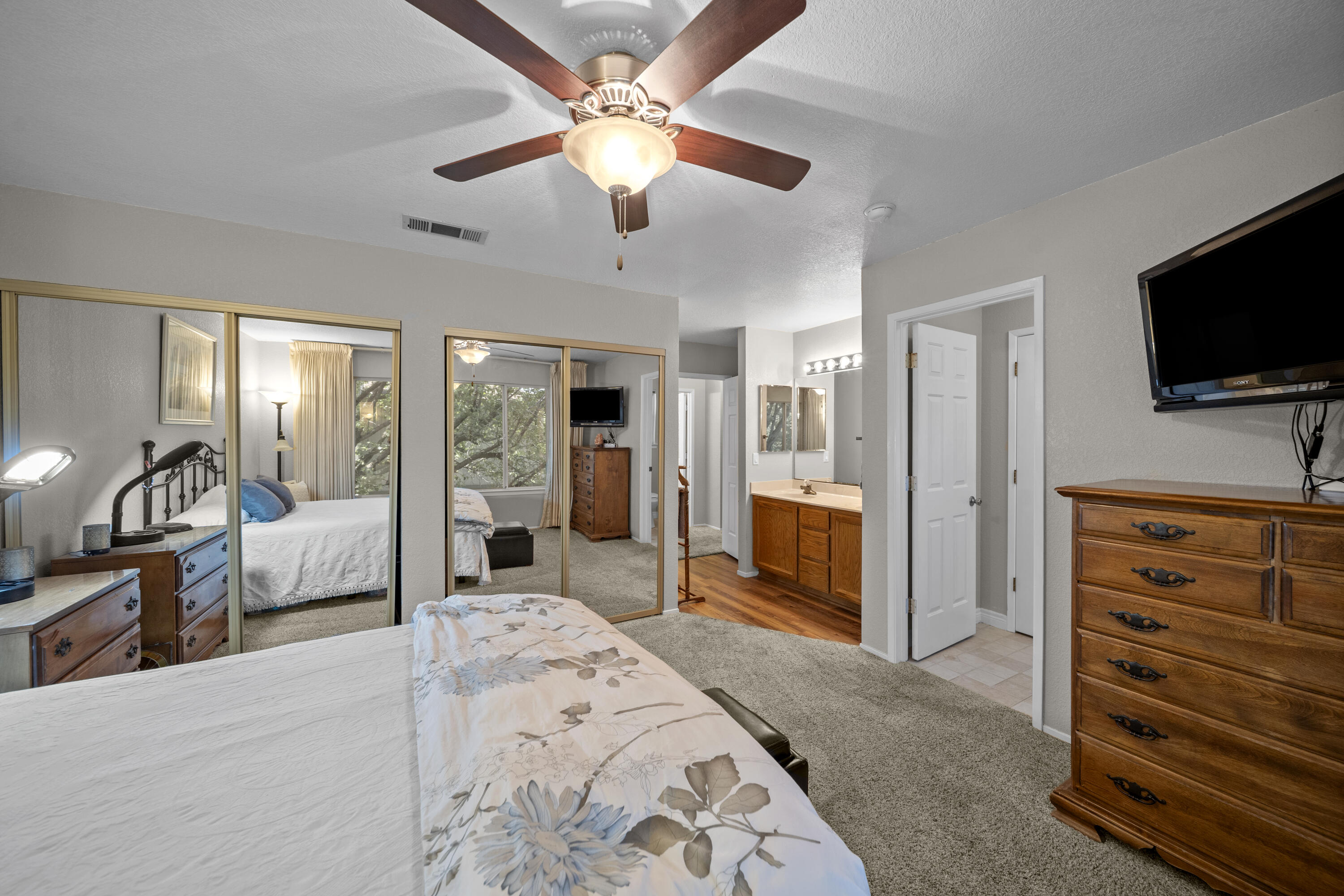 200 Ridgetop Drive, Unit 26 Redding, CA 96003 - Photo 13 of 27 a bedroom with furniture and a flat screen tv