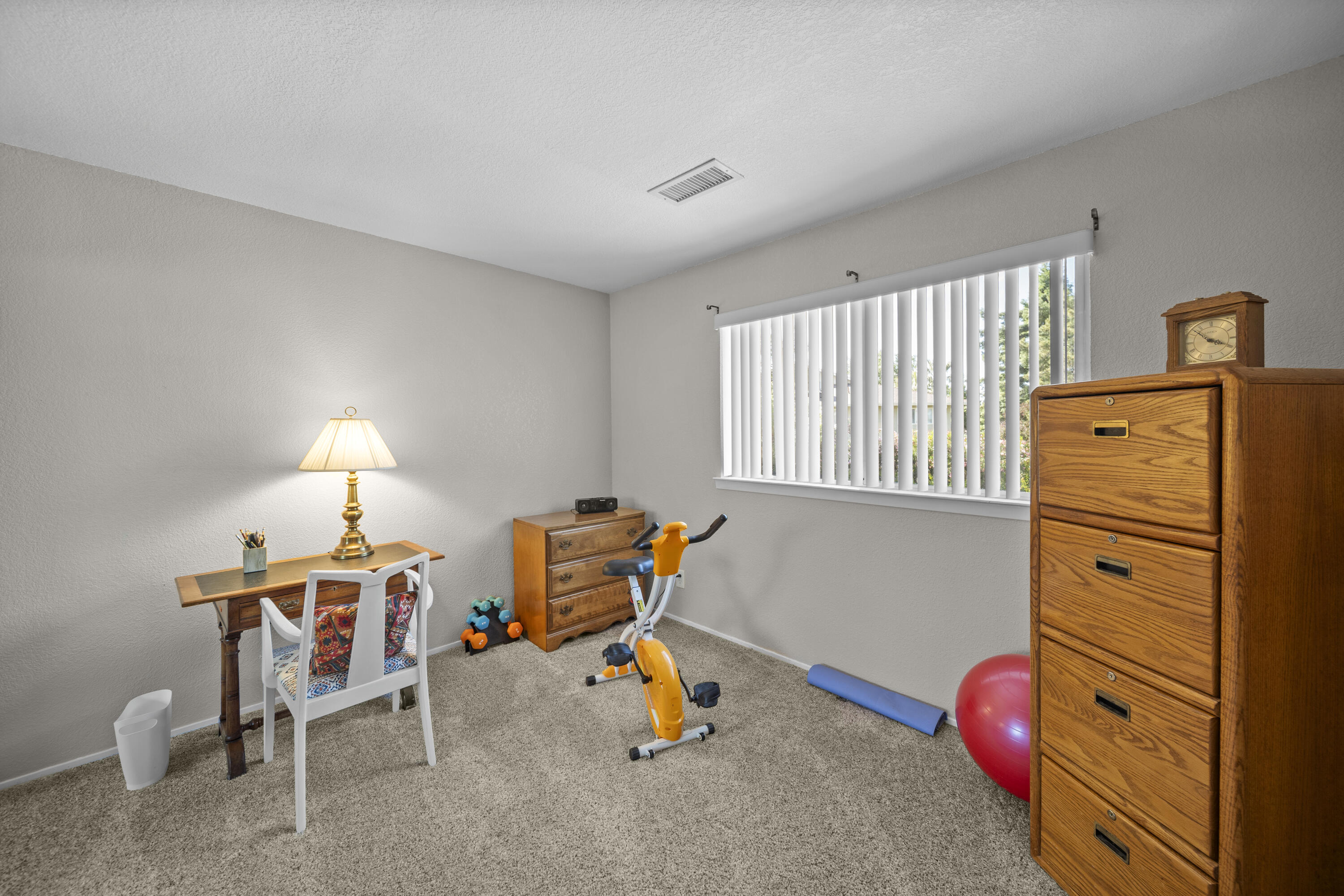 200 Ridgetop Drive, Unit 26 Redding, CA 96003 - Photo 15 of 27 a bedroom with furniture and a lamp