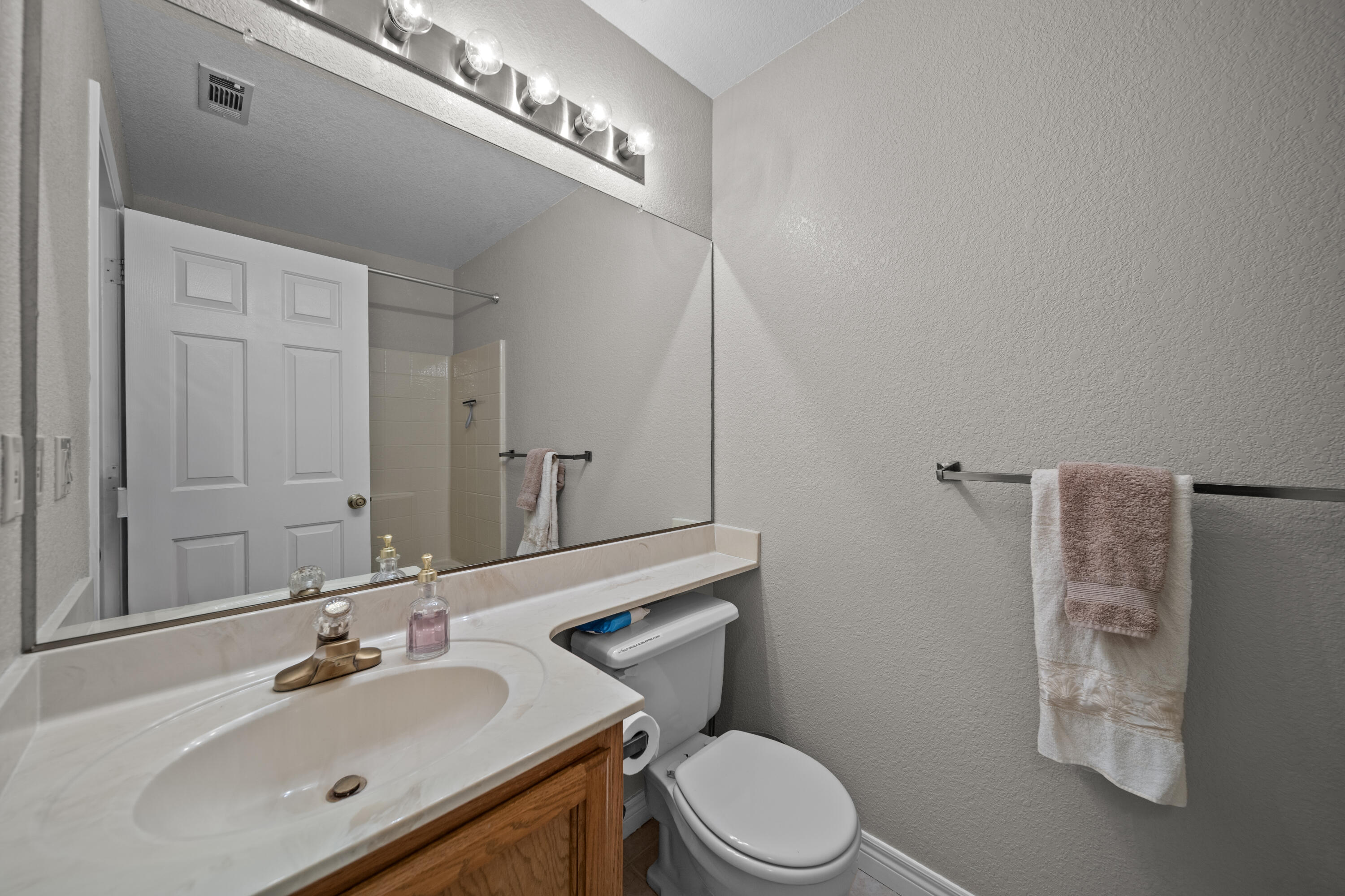 200 Ridgetop Drive, Unit 26 Redding, CA 96003 - Photo 20 of 27 a bathroom with a sink mirror vanity and toilet