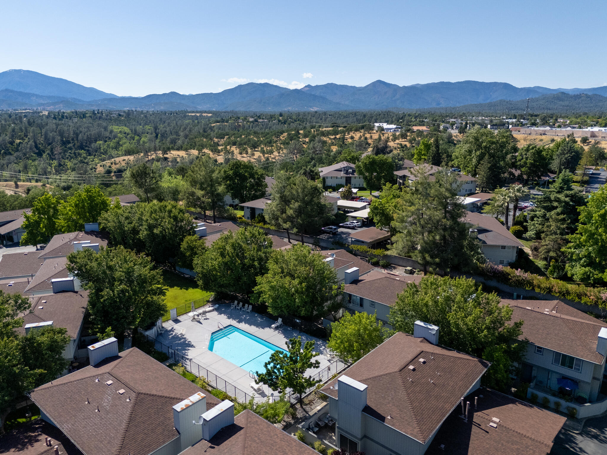 200 Ridgetop Drive, Unit 26 Redding, CA 96003 - Photo 24 of 27 an aerial view of a city with lots of residential buildings and mountain view in back