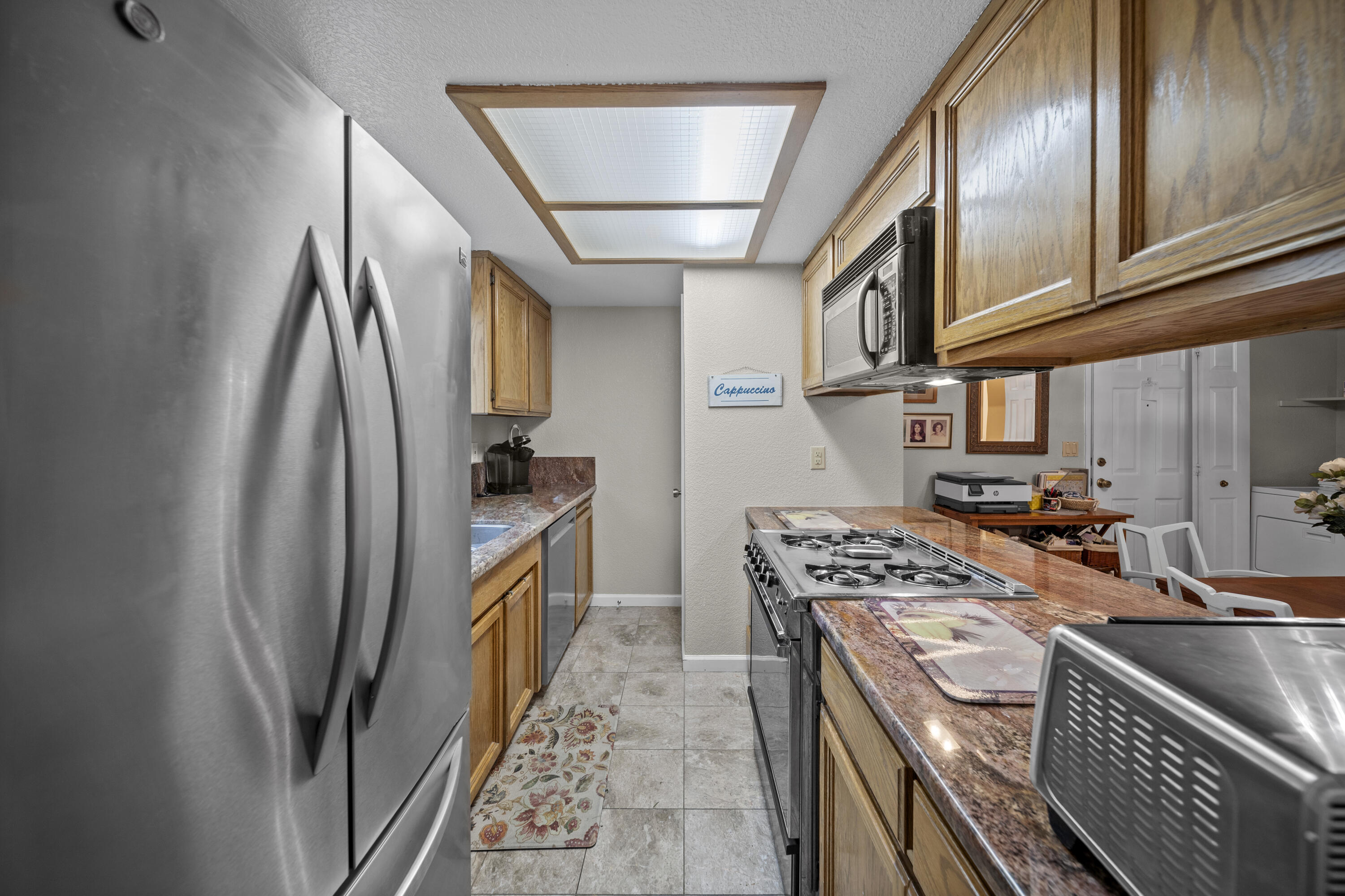 200 Ridgetop Drive, Unit 26 Redding, CA 96003 - Photo 9 of 27 a kitchen with stainless steel appliances granite countertop a refrigerator a stove and a sink