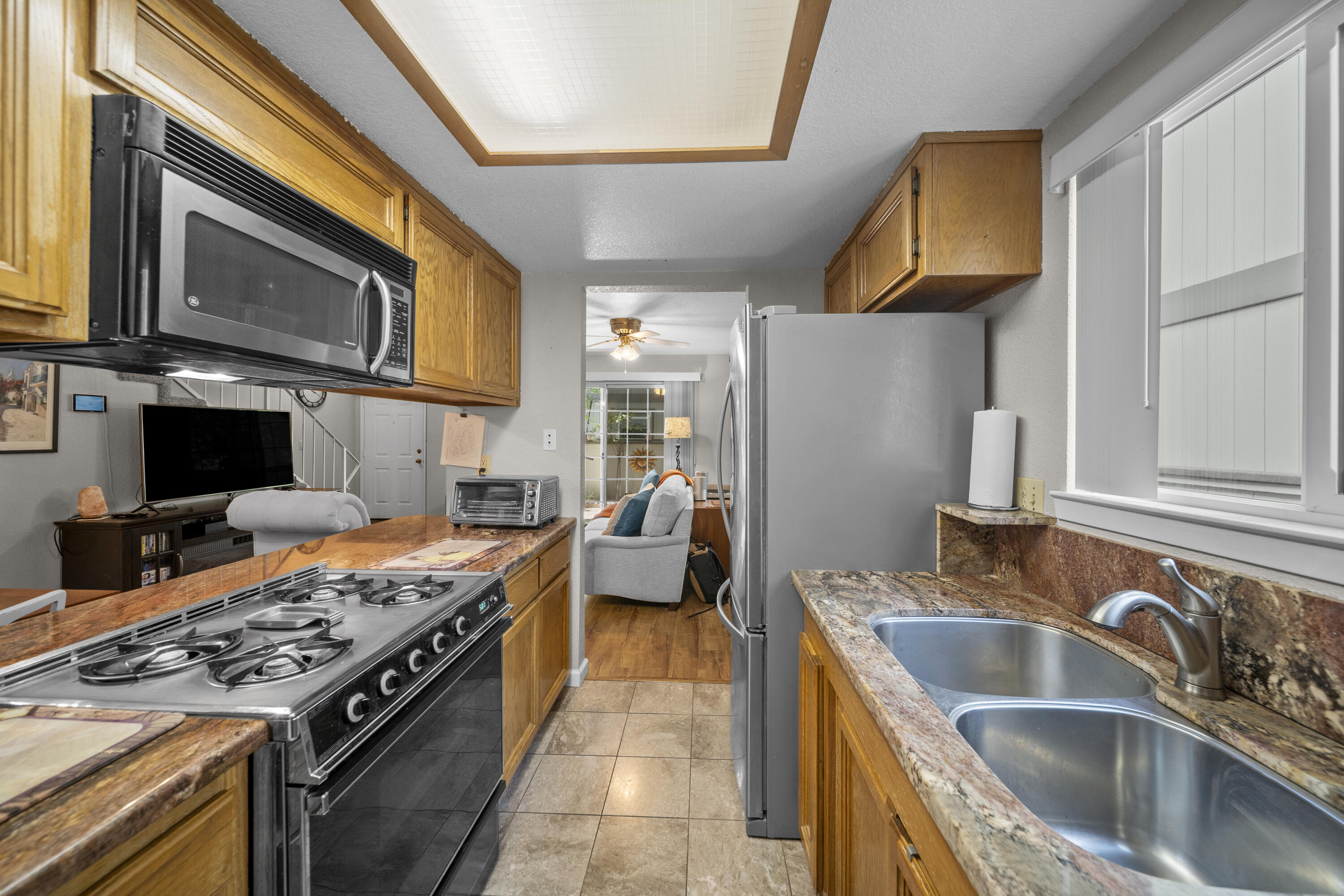 200 Ridgetop Drive, Unit 26 Redding, CA 96003 - Photo 10 of 27 a kitchen with stainless steel appliances granite countertop a stove and a sink