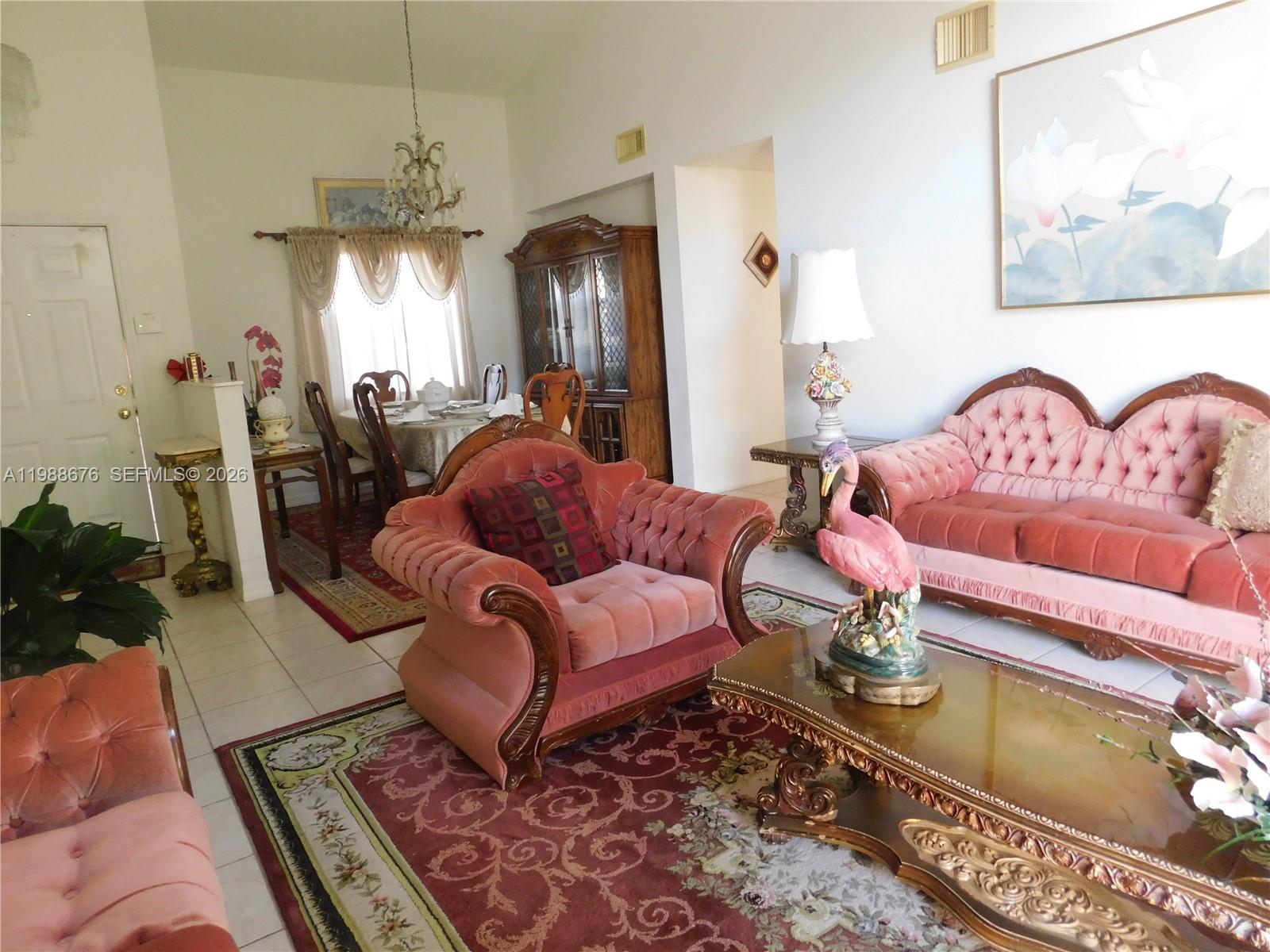 15871 Southwest 82nd Street Miami, FL 33193 - Photo 4 of 7 a living room with furniture a chandelier and a rug