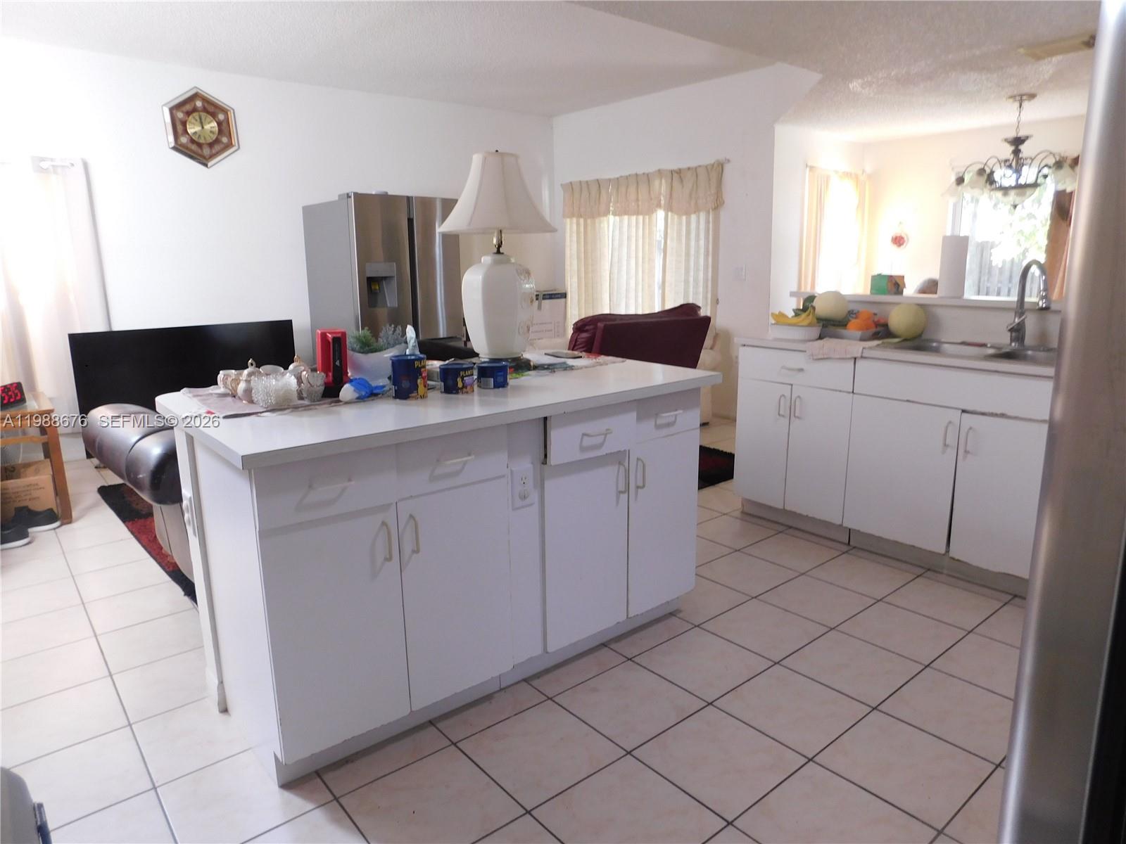 15871 Southwest 82nd Street Miami, FL 33193 - Photo 6 of 7 a kitchen that has a sink and a stove in it