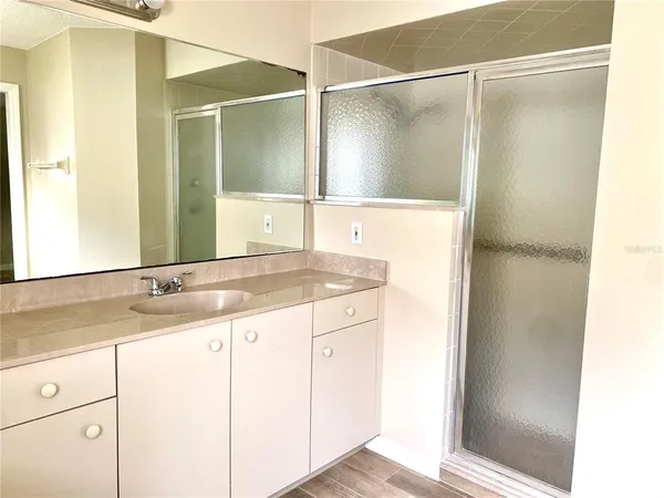 a bathroom with a granite countertop sink and a mirror