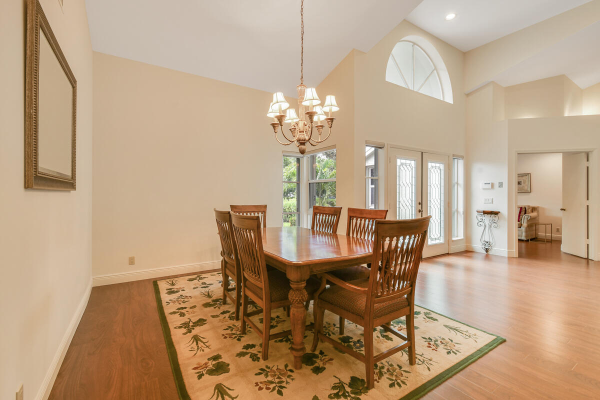 13312 Northwest Maplewood Road Palm City, FL 34990 - Photo 21 of 69 a view of a dining room with furniture and wooden floor