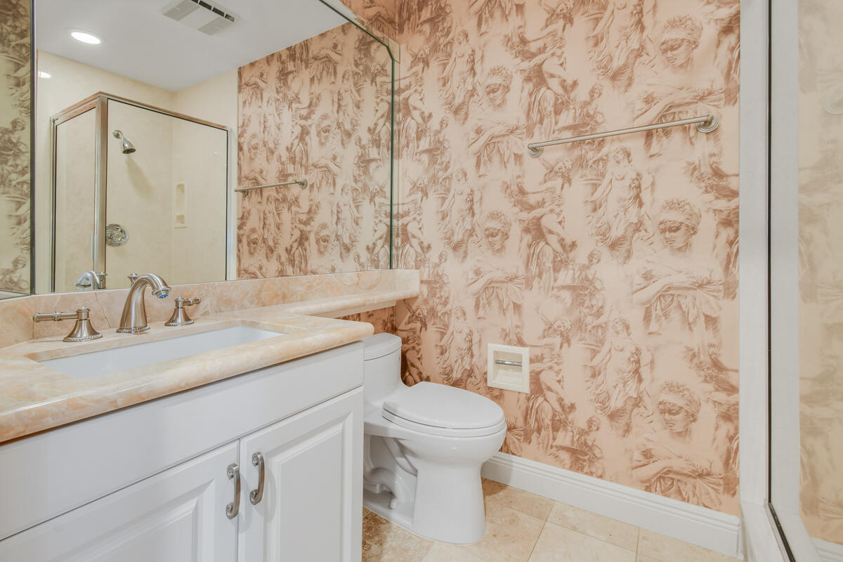 13312 Northwest Maplewood Road Palm City, FL 34990 - Photo 25 of 69 a bathroom with a granite countertop sink and a toilet