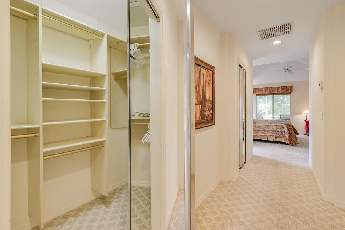 13312 Northwest Maplewood Road Palm City, FL 34990 - Photo 28 of 69 a view of a bedroom with a furniture and a ceiling fan