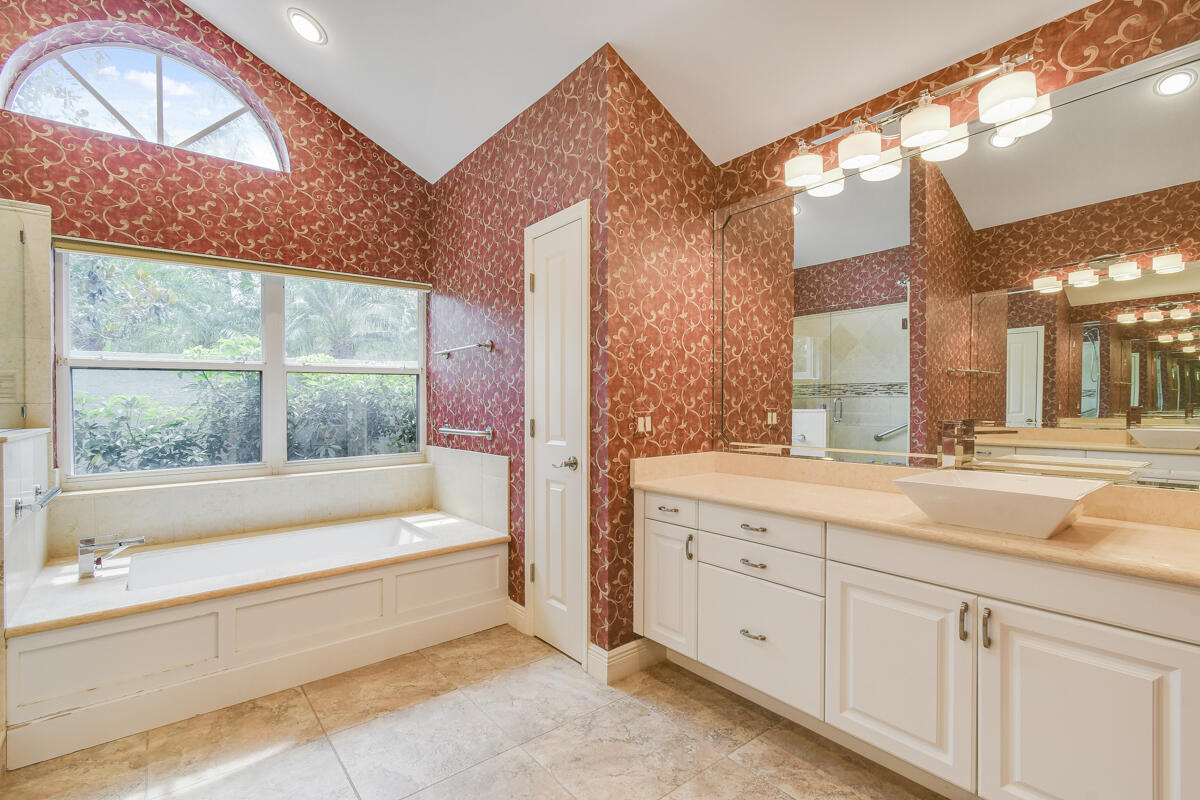 13312 Northwest Maplewood Road Palm City, FL 34990 - Photo 34 of 69 a spacious bathroom with a bathtub and a sink