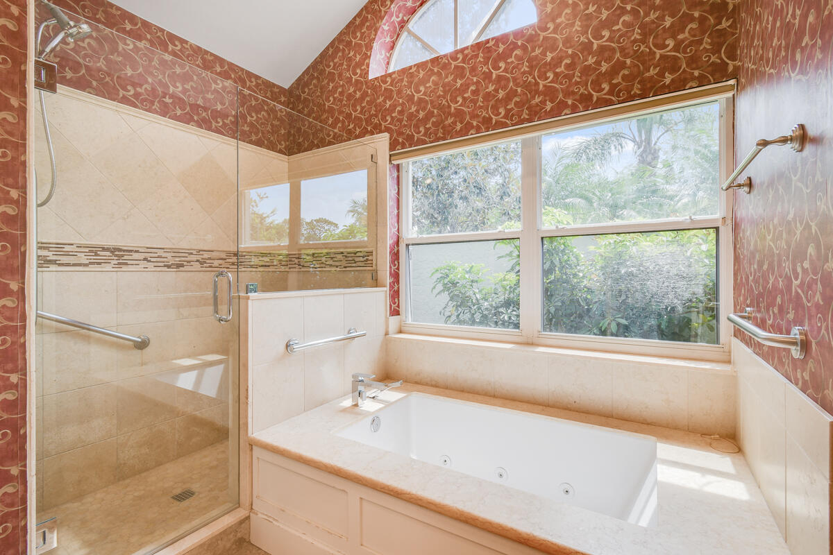 13312 Northwest Maplewood Road Palm City, FL 34990 - Photo 35 of 69 a bathroom with a bathtub and a shower