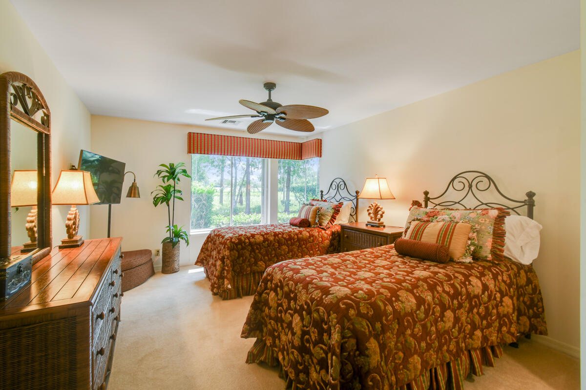 13312 Northwest Maplewood Road Palm City, FL 34990 - Photo 36 of 69 a bedroom with two beds and a large window