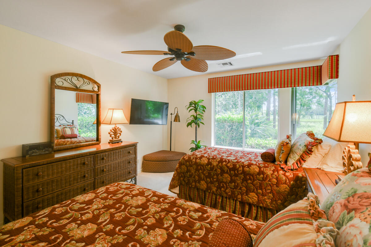 13312 Northwest Maplewood Road Palm City, FL 34990 - Photo 37 of 69 a bed room with two bed and a large window