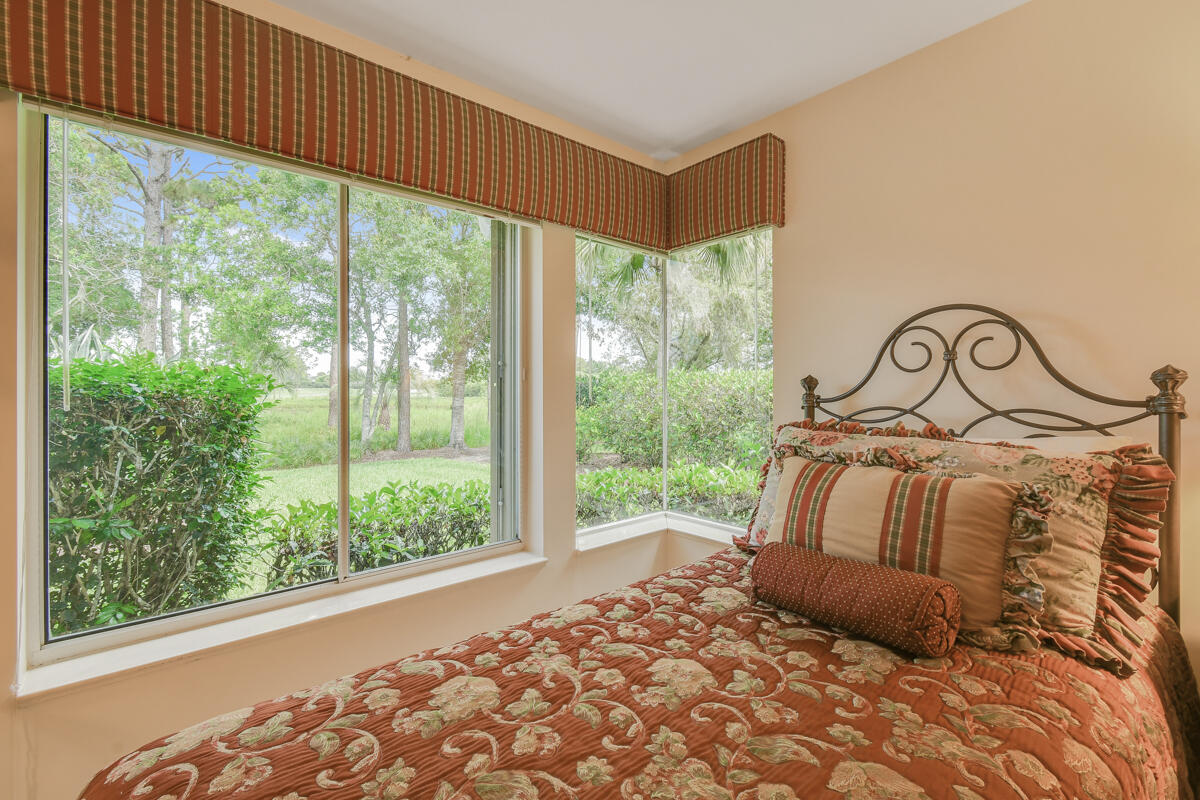 13312 Northwest Maplewood Road Palm City, FL 34990 - Photo 38 of 69 a bedroom with a bed and a window