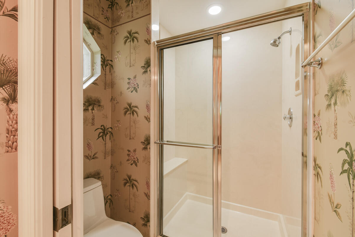 13312 Northwest Maplewood Road Palm City, FL 34990 - Photo 40 of 69 a bathroom with a shower and a glass door