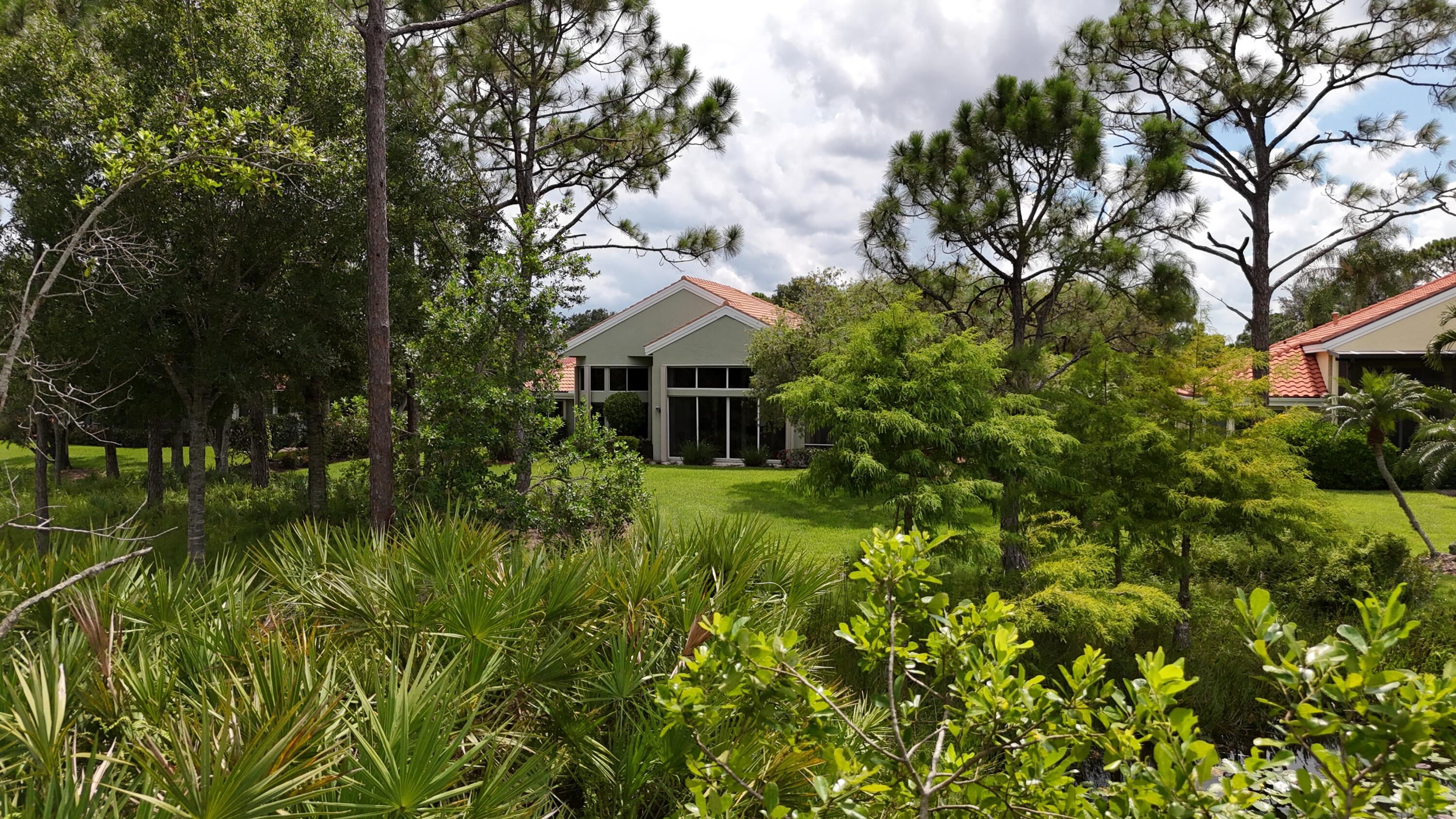 13312 Northwest Maplewood Road Palm City, FL 34990 - Photo 44 of 69 a view of a house with a yard